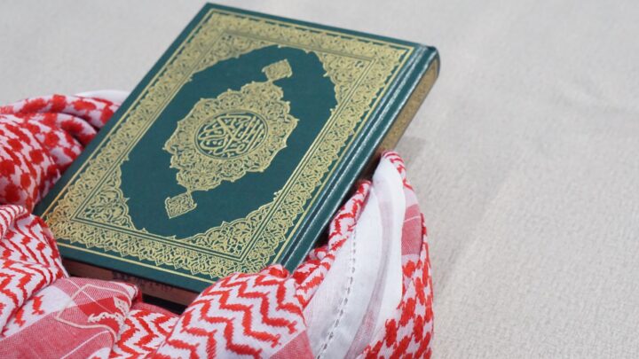 green and gold book on red and white textile